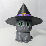 Gray cat figurine with a tall black witch hat, complete with a sparkling purple band.