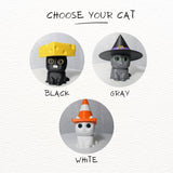 Display of available cat figurine colors: black, gray, and white, shown with hats.