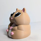 Three-quarter angle of a chubby hamster figurine, showing its little pink feet and big glossy eyes.