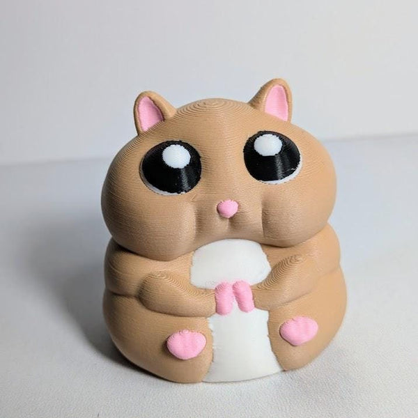 Close-up front view of a hamster figurine with giant eyes and tiny paws.