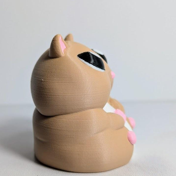 Side profile of a chunky hamster figurine showing its soft curves and tiny hands