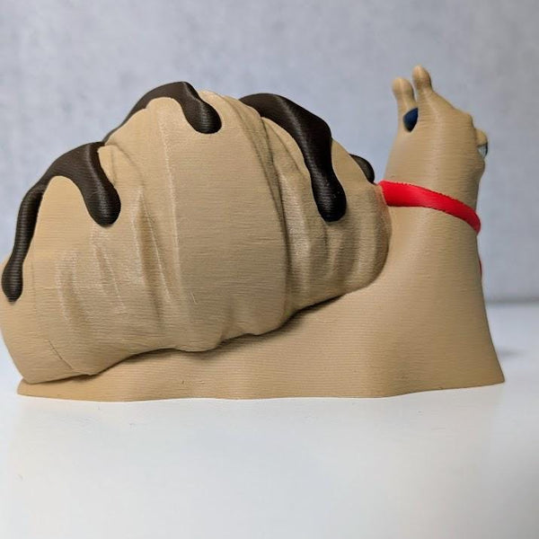 Le Escargôutier™, a croissant snail with a mustache and red neckerchief, gazes smugly to the side with his flaky shell coiled behind him.