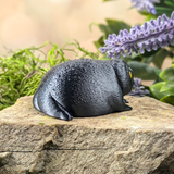 Right side view of the figurine showing its curved form, droopy pose, and sad vibe.