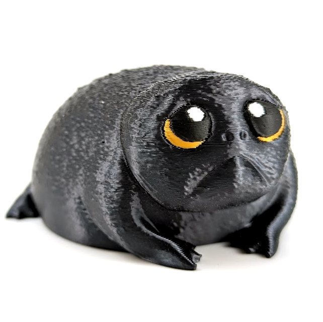 Depressed dumpling is a sad looking african rain frog. He looks like a sad avocado with his shiny black textured skin and huge yellow eyes.