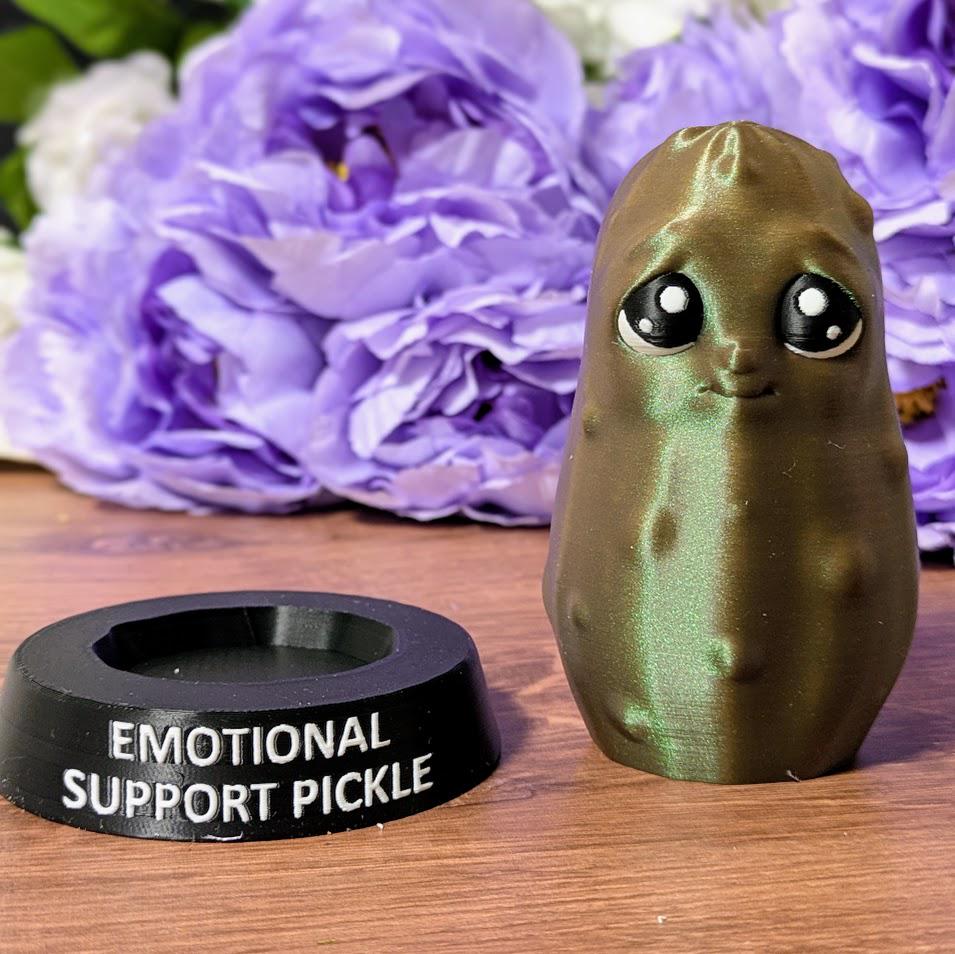 Emotional Support Pickle next to black nameplate stand with text “EMOTIONAL SUPPORT PICKLE.”