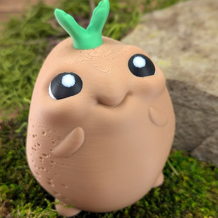 A close-up of the potato's cheerful face with large black and white cartoon eyes and a slight smile.