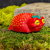 Right side of the frog figurine showing its soft curves and subtle seed texture