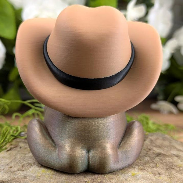 Back view of Cowboy Frog showing the cowboy hat and the tied bandana knot, highlighting the frog's rounded shape and shimmer detail.
