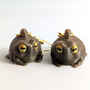 Grumpy frog earrings on a white background showing front view of both frogs and gold earring hooks