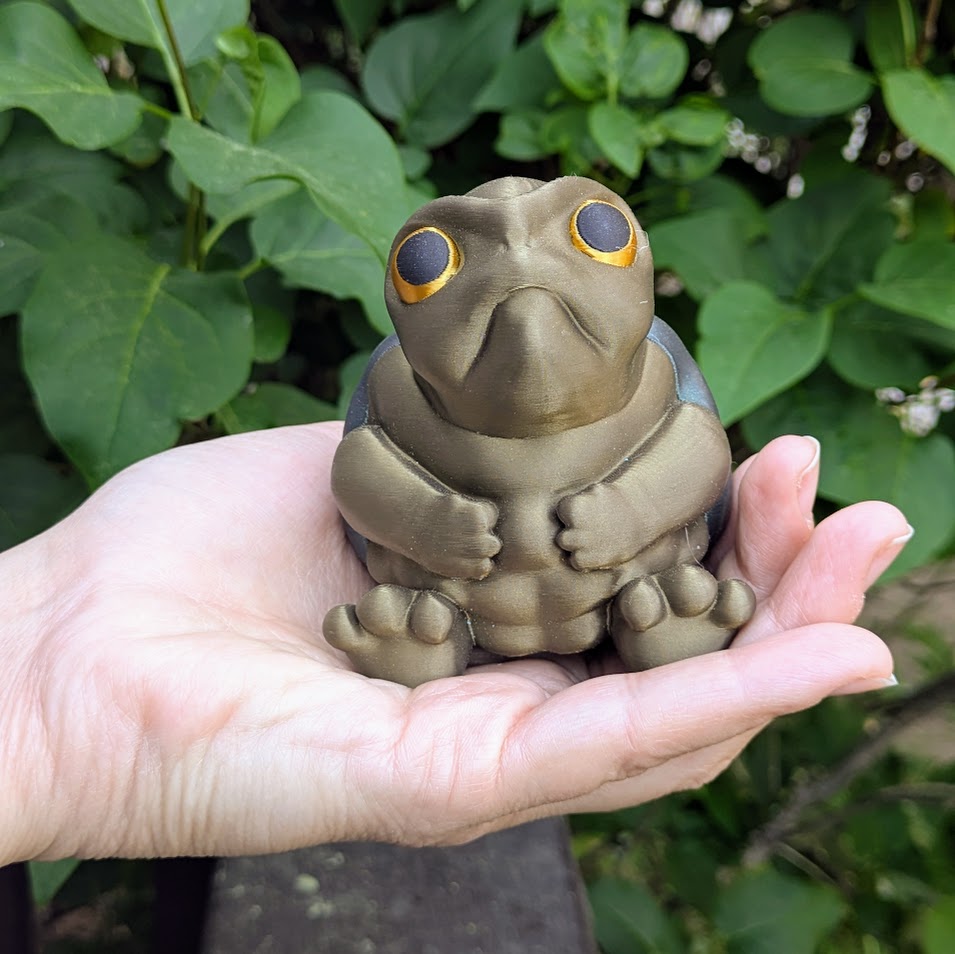 Angled view of large Judgmental Turtle™ in hand, showing face and body texture.