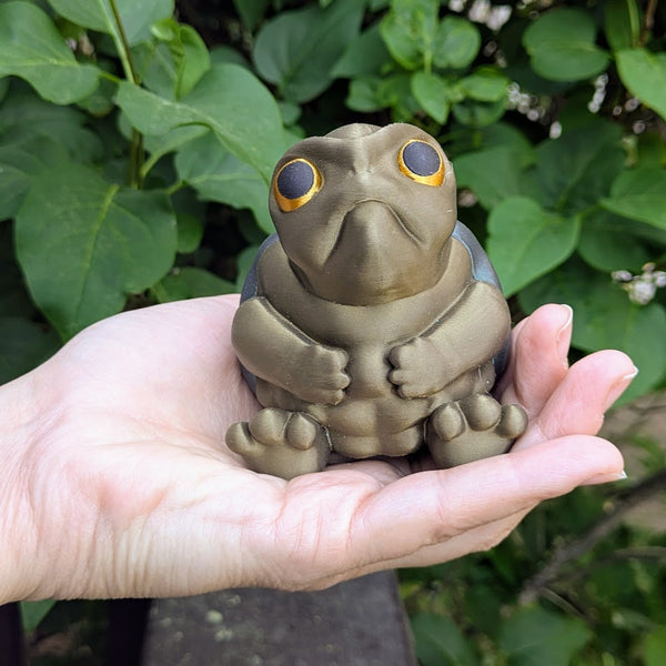 Angled view of large Judgmental Turtle™ in hand, showing face and body texture.