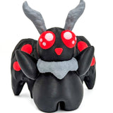 A picture of an adorable mothman figurine on a white background.