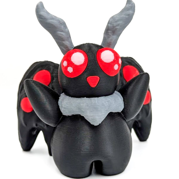 A picture of an adorable mothman figurine on a white background.