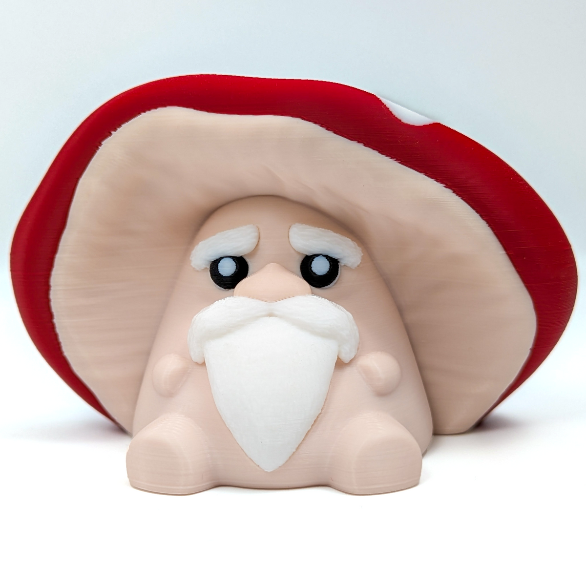 A wise old mushroom, with a glorious beard, sits on a white background.