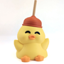 A very silly duck with a plunger on his head sits on a white background.
