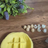 Video preview showing a yellow chicken-shaped tic tac toe board with white egg and chicken playing pieces arranged on a wooden surface.