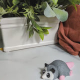 A short video featuring a round, confused possum figurine with a big pink tail — lovingly referred to as the Blob Possum.