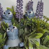 A video still of a wide-eyed derpy pigeon figurine standing in a jungle of houseplants, deeply confused but committed to the bit.