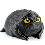 Rage nugget is a black Rainfrog with a sour expression. He has yellow eyes that are full of disdain. He is black in color and looks like an angry avocado.