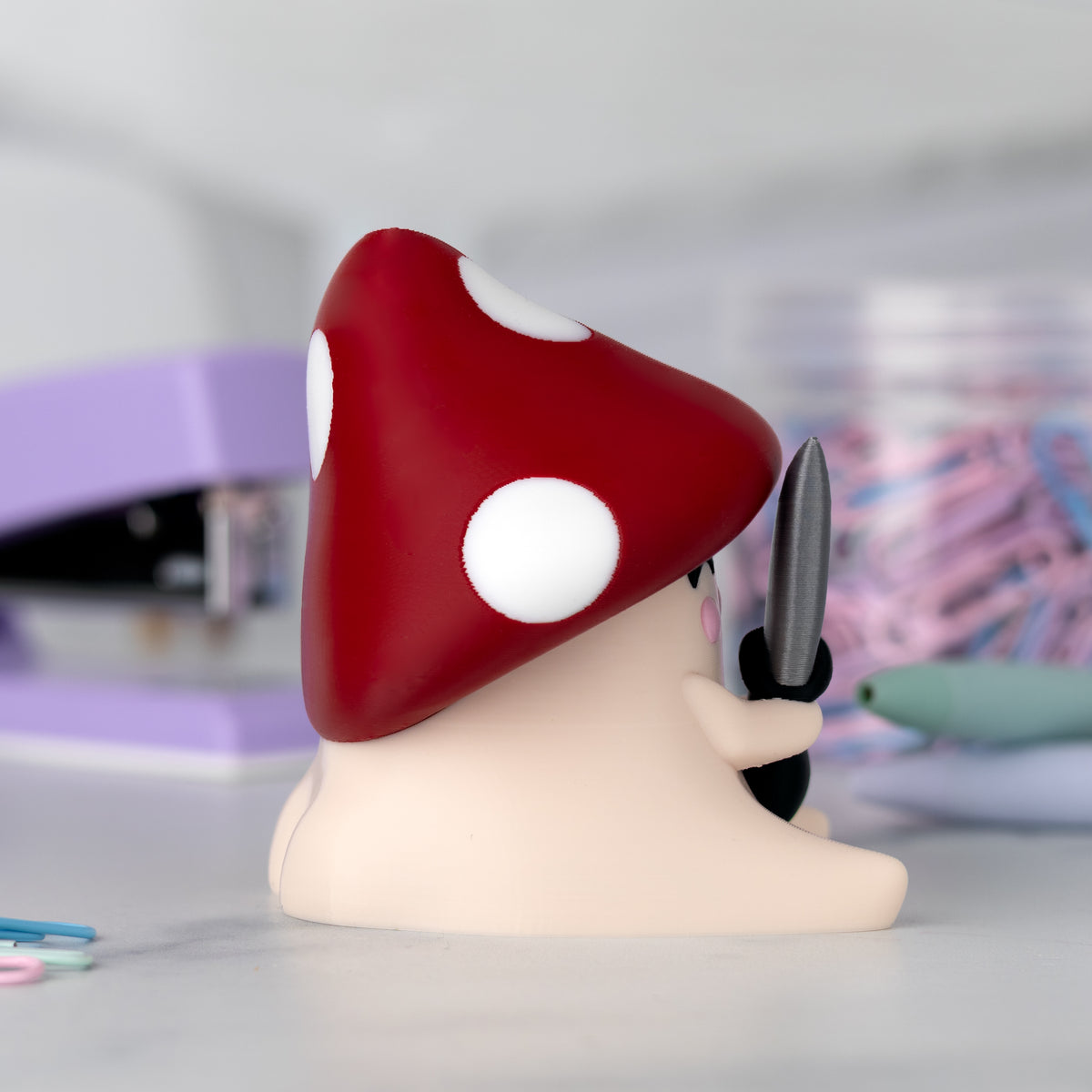 Figurine with a red mushroom cap on a blurred background