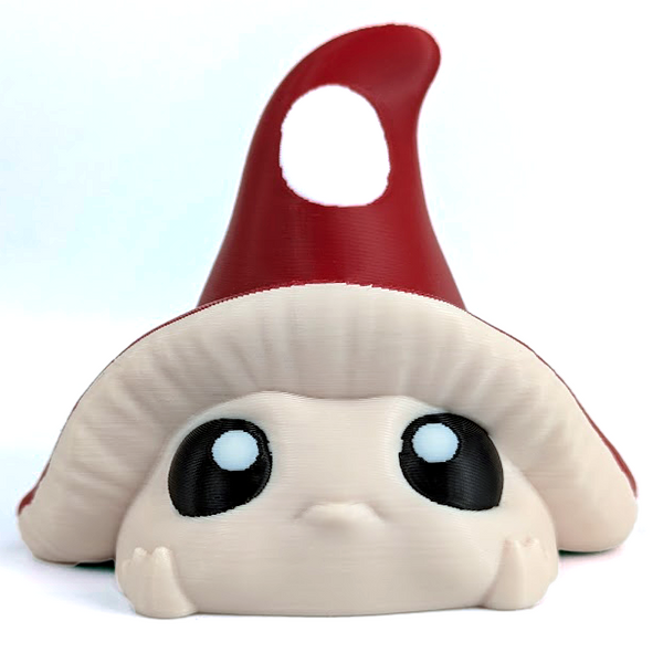 An adorable, shy little mushroom buddy with a red spotted hat and large eyes sits on a white background.