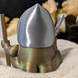 Angled rear view of Sir Glorb™ with sword visible at his side and helmet reflecting soft light.