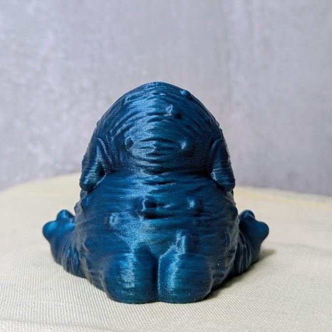 Rear view of a deep blue Squonk, because even his back is overwhelmed by grief.