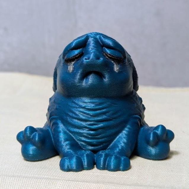 Dark sparkly blue Squonk with a plain backdrop, fully committed to aesthetic despair.