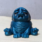 Dark sparkly blue Squonk with a plain backdrop, fully committed to aesthetic despair.