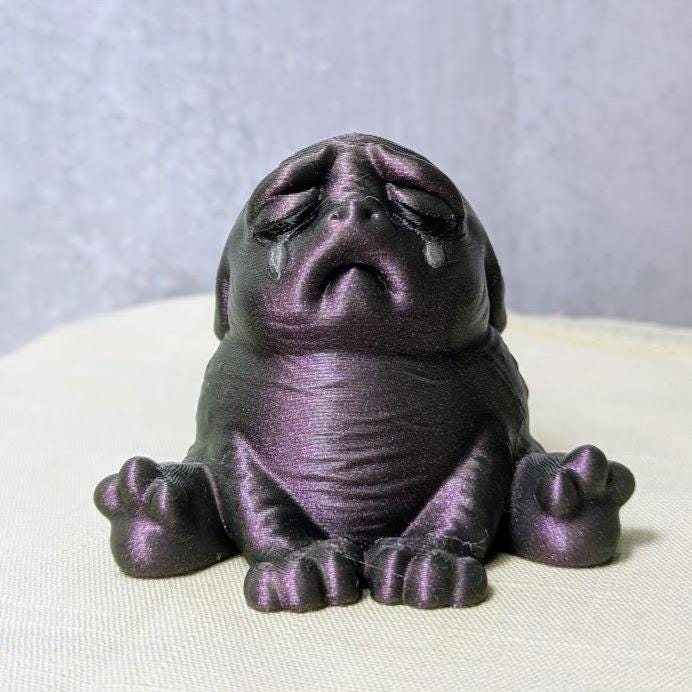 Plum Despair Purple Squonk figurine on white backdrop, quietly sobbing in gothic shades.