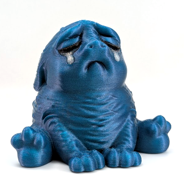 A crying blue Squonk sits on a white background. He is shiny and sparkling, and full of despair.