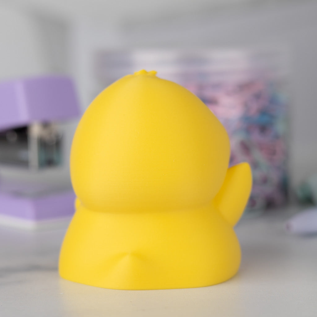 Back view of a yellow duck on a blurred background