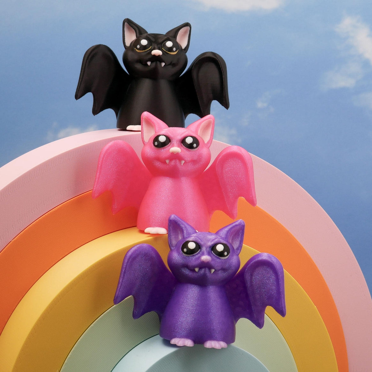 Set of three bats in pink, purple, and black, original 3D printed bat design