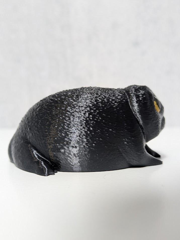 Side profile of the Depressed Dumpling™ figurine facing right, capturing its hunched pose and droopy vibe.