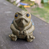 Judgmental Turtle™ front-facing on wood surface with a stern expression.