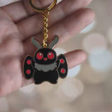 A video showing the cute mothman enamel keychain from all angles