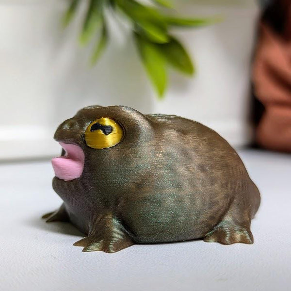 The screaming rainfrog from the other side, eyes wide and mouth unhinged like it just stubbed a toe it doesn’t have.