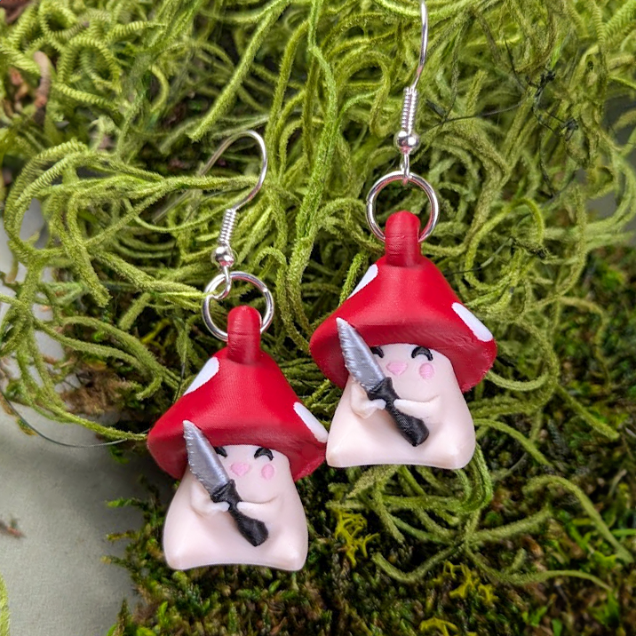 Shroomshank earrings posed on green moss for a whimsical forestcore vibe