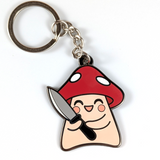 A cute enamel keychain featuring a mushroom holding a knife.