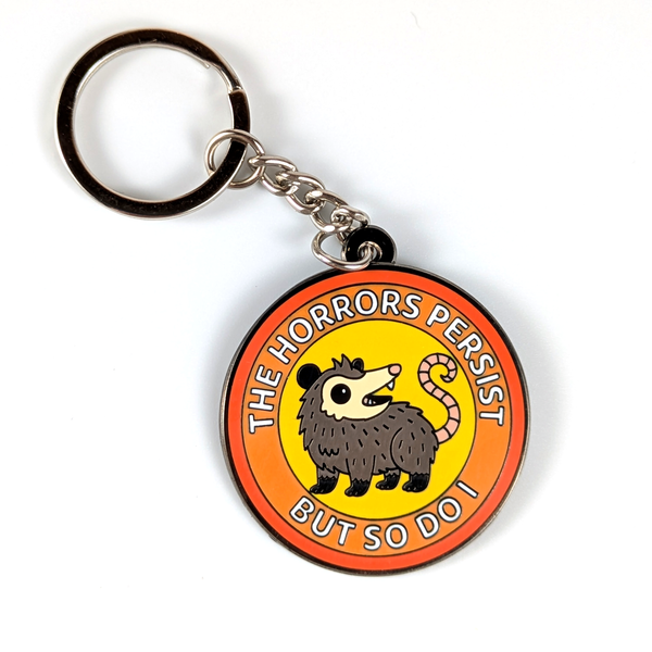 Possum enamel keychain with quote on plain white background
